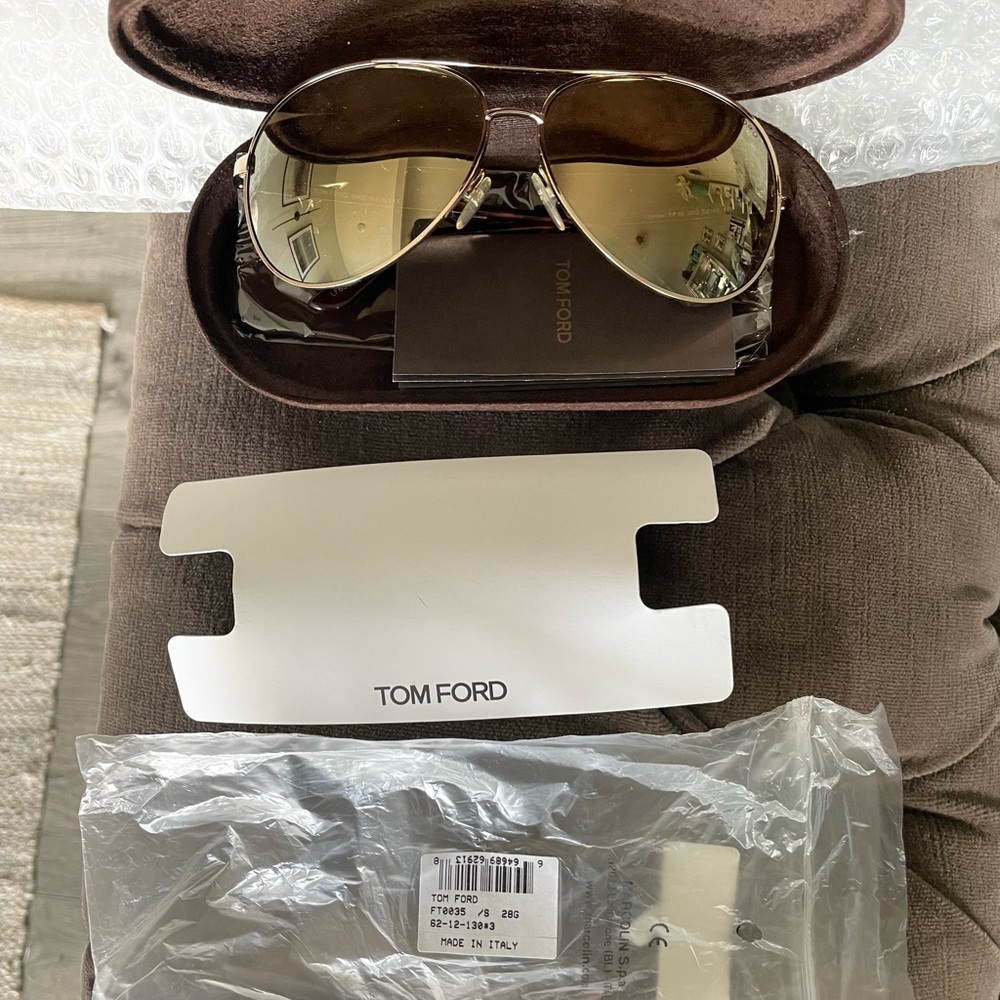 Tom Ford mirrored aviator glasses.